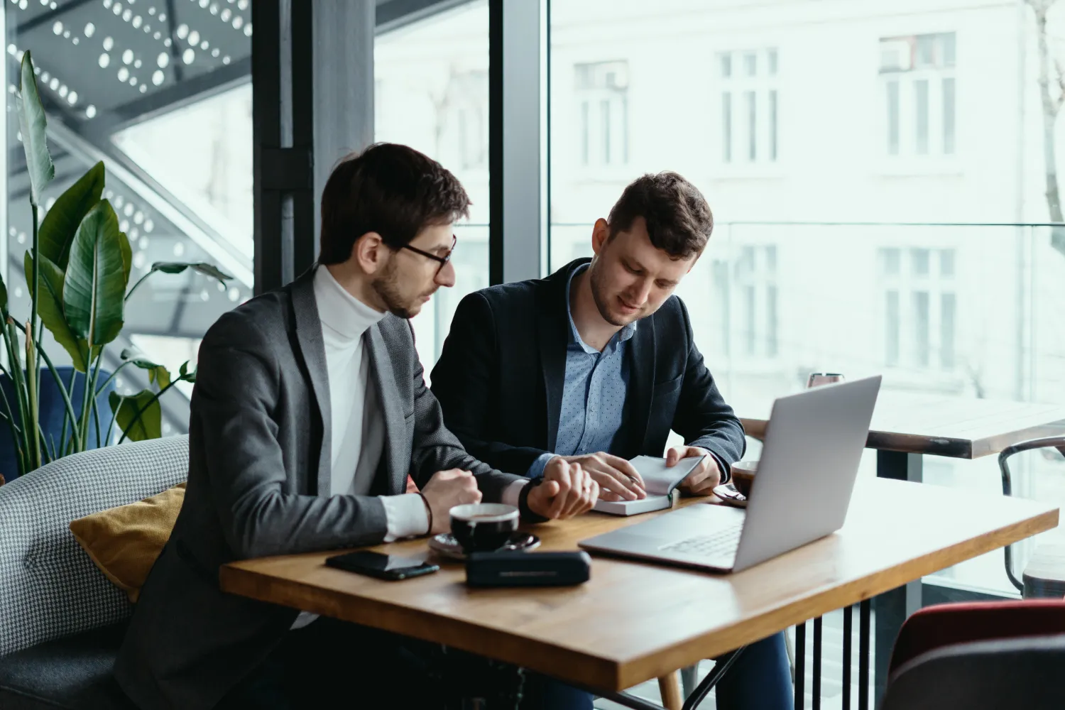 Two young businessman having a successful meeting at restaurant Two young businessman having a successful meeting at restaurant