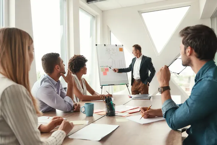 project-results-mature-businessman-standing-near-whiteboard-explaining-something-his-colleagues-teamwork-meeting project-results-mature-businessman-standing-near-whiteboard-explaining-something-his-colleagues-teamwork-meeting